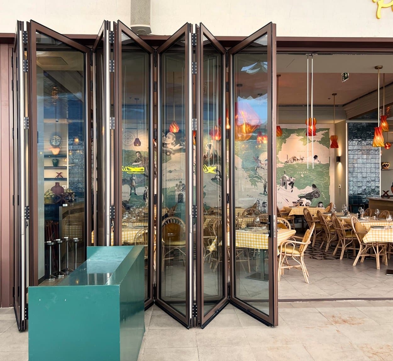 Custom multi-leaf aluminum folding patio door installation in Dubai